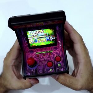 The actual pink Arcade Cabinet mini console held in both hands with a game menu on its colour screen