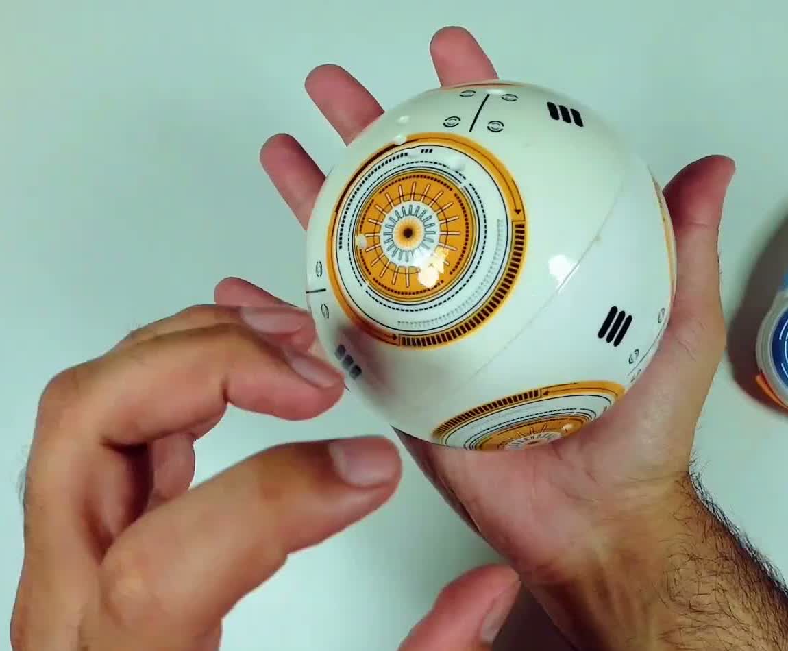 Close-up of the droid ball's rolling body in hand, showing the printed circular panel detail