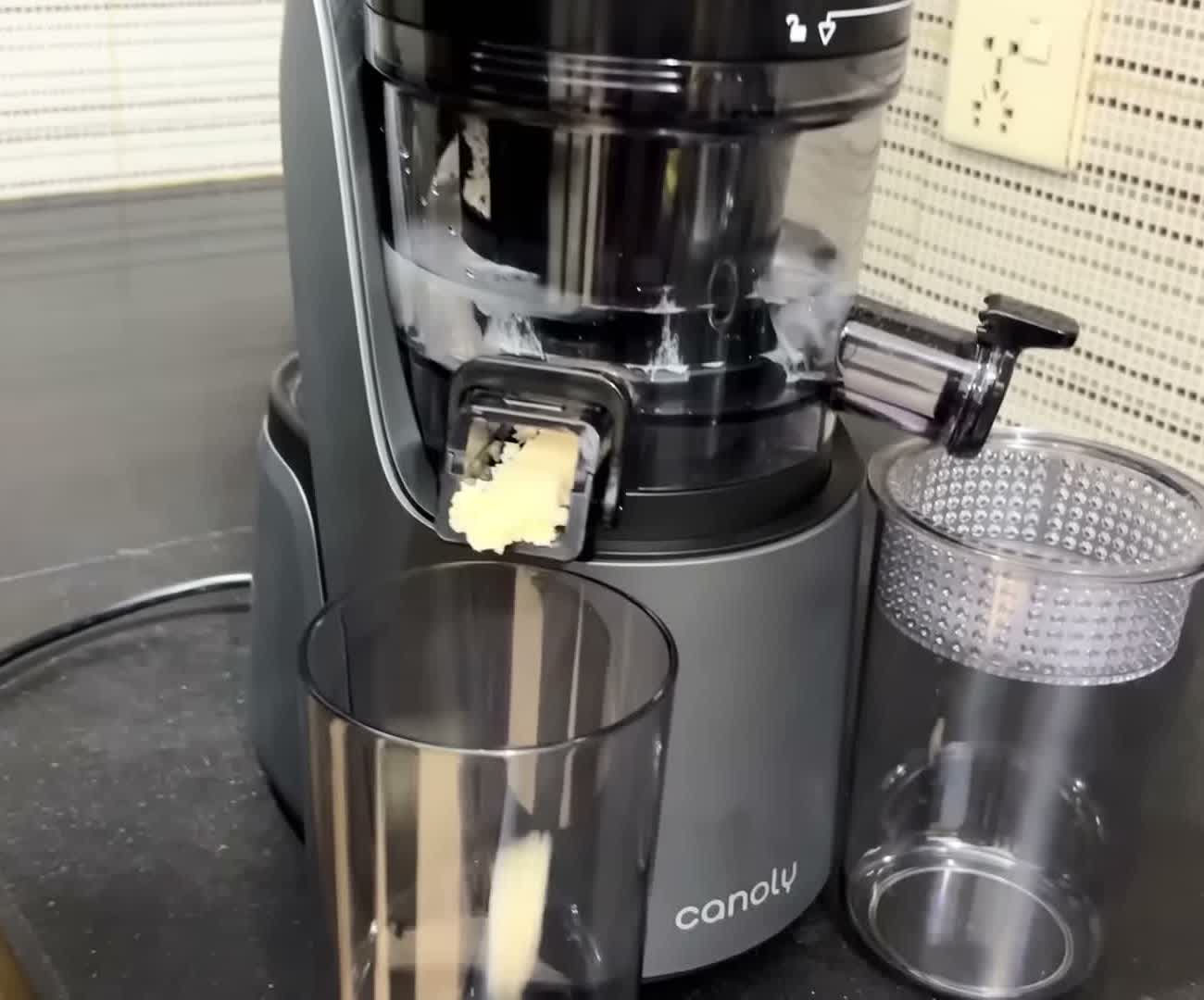 Canoly C16 juicer in sorbet mode, extruding frozen fruit sorbet into a glass