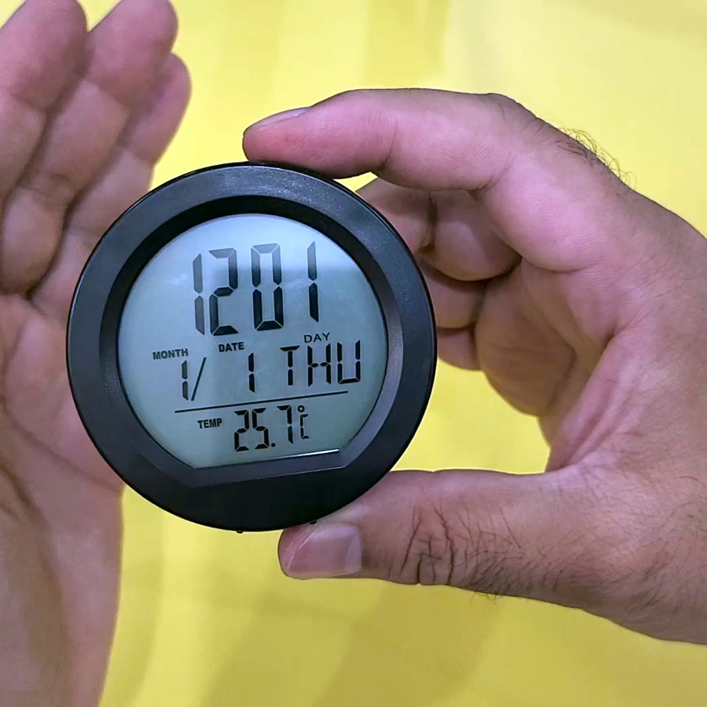 Close-up of the solar dashboard clock LCD, with the large time readout above the month, date and day row and the temperature in Fahrenheit below