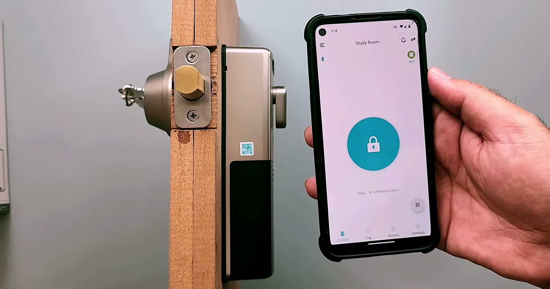 The fitted Lockly Flex Touch alongside a phone showing the Lockly app's unlock button