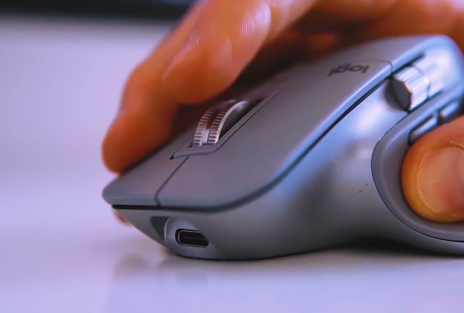 Hand resting on the Logitech MX Master 3 with the ridged MagSpeed scroll wheel and USB-C port in view