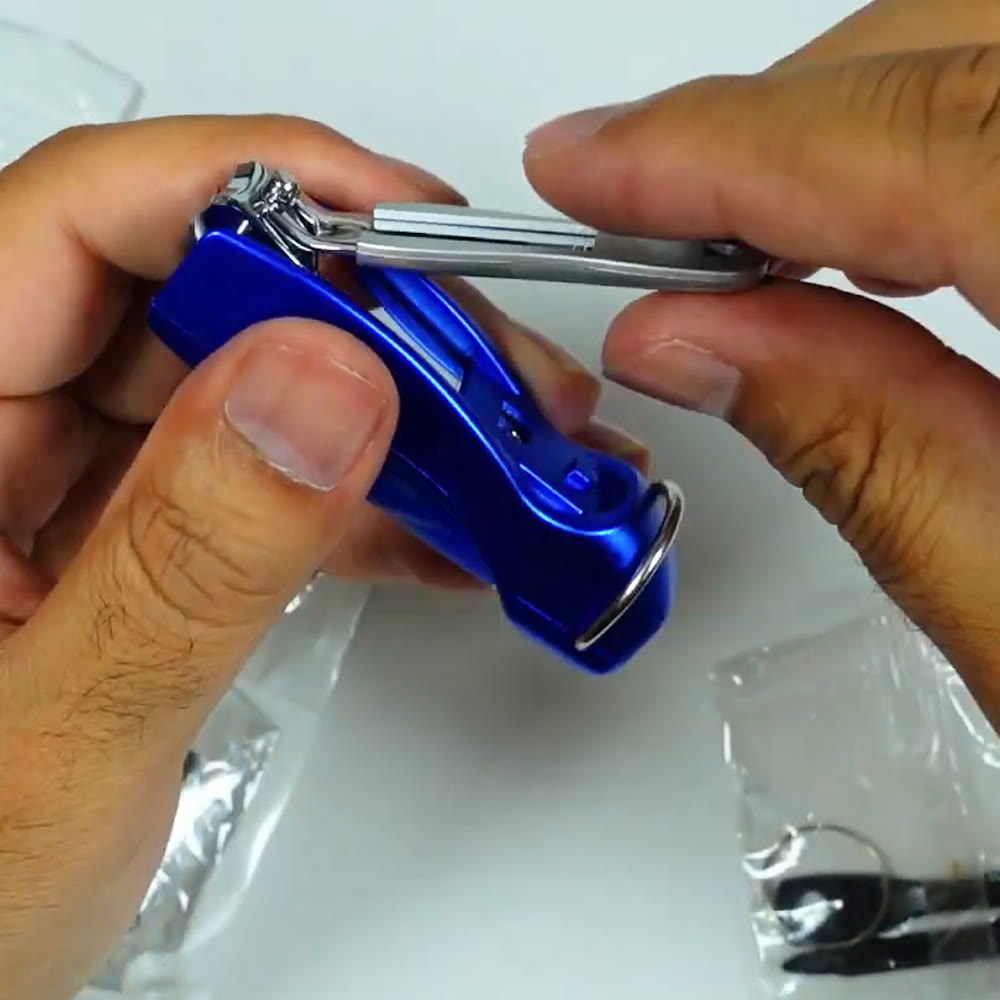 Blue metal pen keychain multitool held in hand with the nail clipper lever swung open