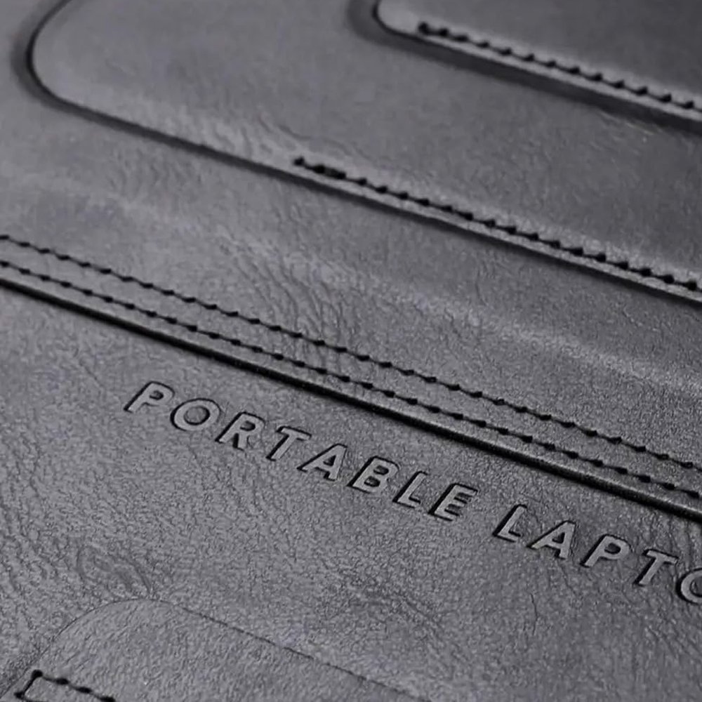 Close-up of the PUNCUBE lap desk stitched leather surface