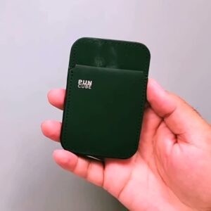 The actual dark green PUNCUBE Minimal Wallet 3.0 held in hand, showing its card pocket